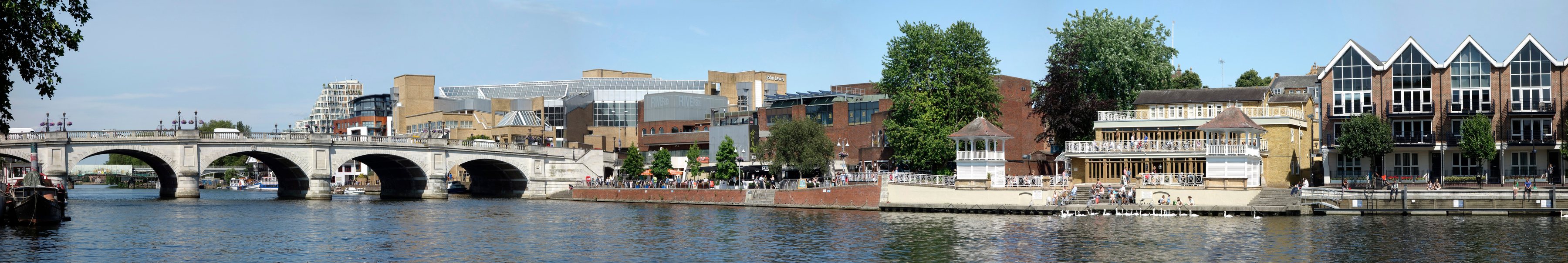 Panorama of the River Thames at Kingston upon Thames, showing Kingston Bridge, the riverside bars and restaurant terraces, the bandstand and the John Lewis and Riverside buildings